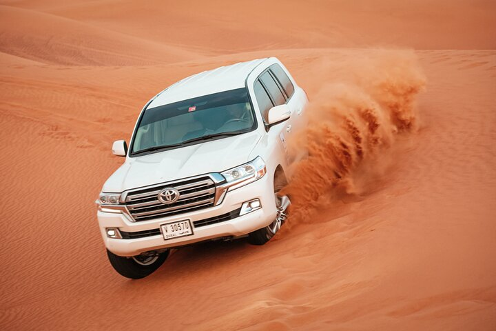 Experience the rush of dune bashing in the mesmerizing red sands of Dubai where adventure meets stunning desert landscapes making unforgettable memories under the endless sky.